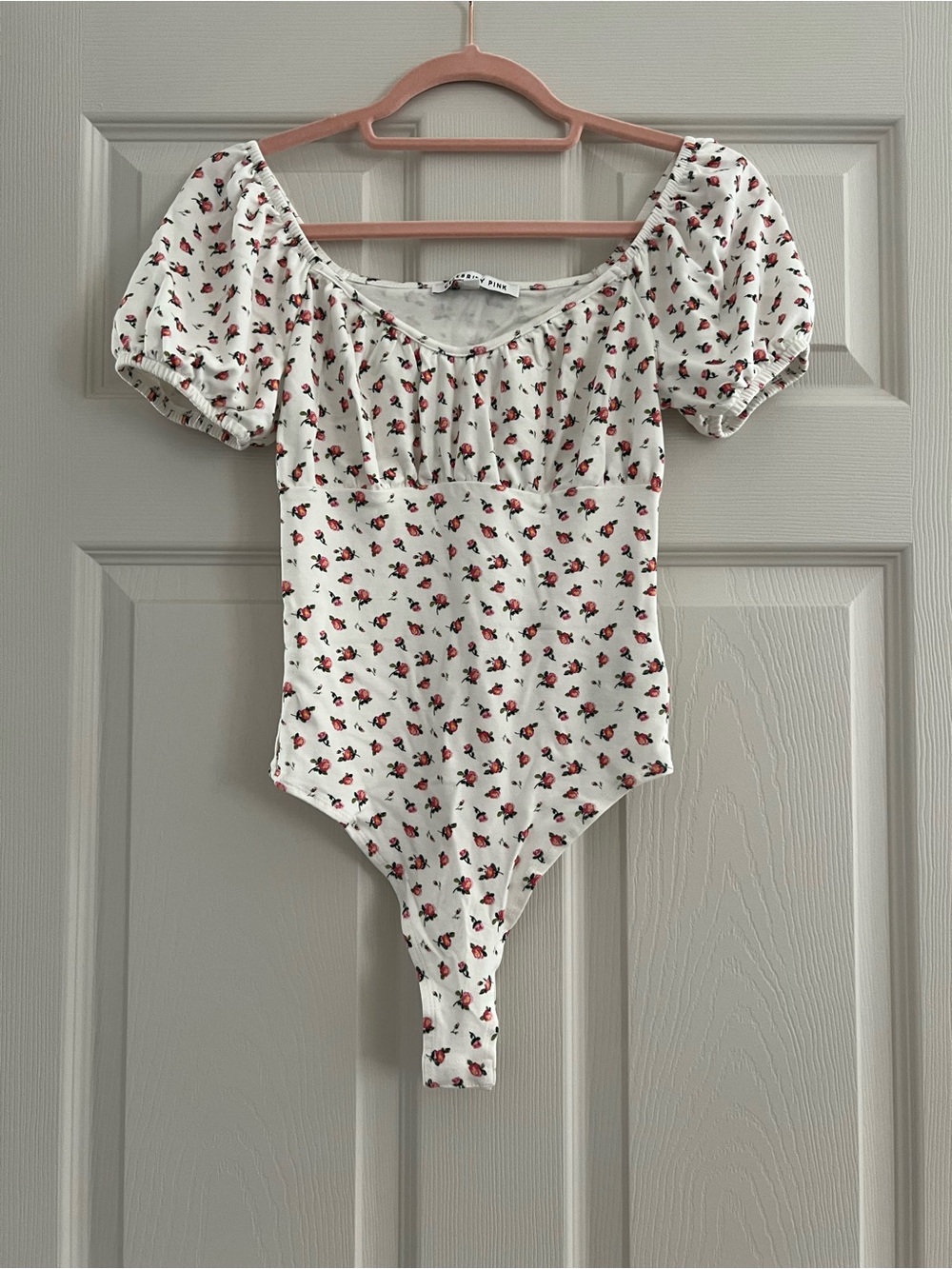 Celebrity Pink White One-Piece Bodysuit with Red Floral Print